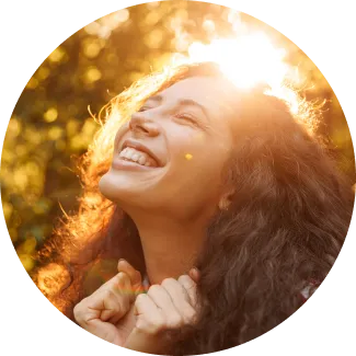 Blessings Program happiness Woman with curly hair basking in sunlight, symbolizing joy and abundance