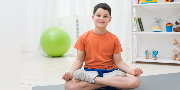 ART EXCEL Program | Kids Development Course Young participant practicing meditation posture during ART EXCEL session in a mindful learning space