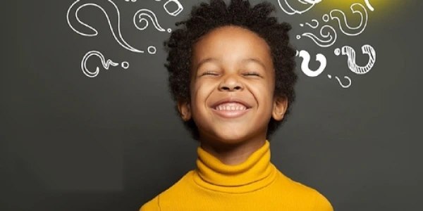 Develop Natural Intuition Young participant in yellow showing joy during intuition process training, surrounded by question marks